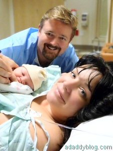 Our baby daughter with my wife and me minutes after birth