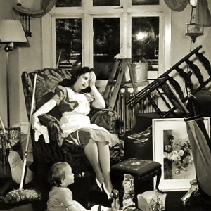 Vintage photo of an exhasted mother and child in a cluttered room